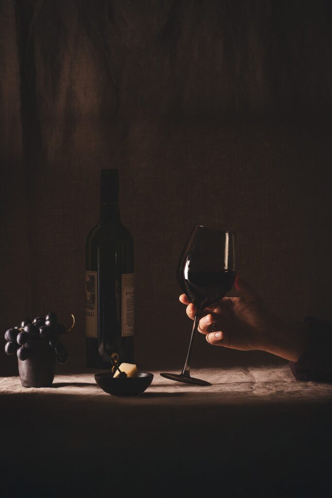 Fotografia kulinarna napoje: lampka wina z przekąskami, elegancka aranżacja potraw lifestyle'owych