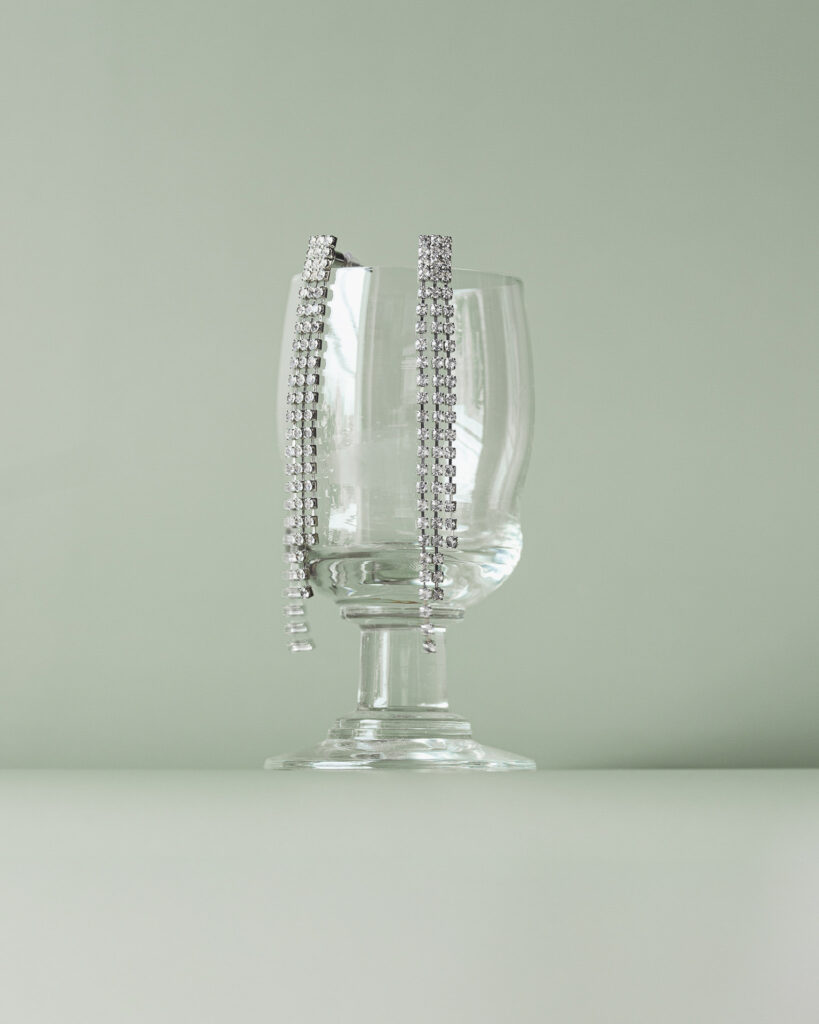 Fotografia produktowa Sylwester: elegancka biżuteria sylwestrowa z kieliszkiem